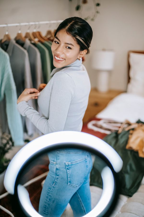 Beauty creator showing an outfit in front of a ring light