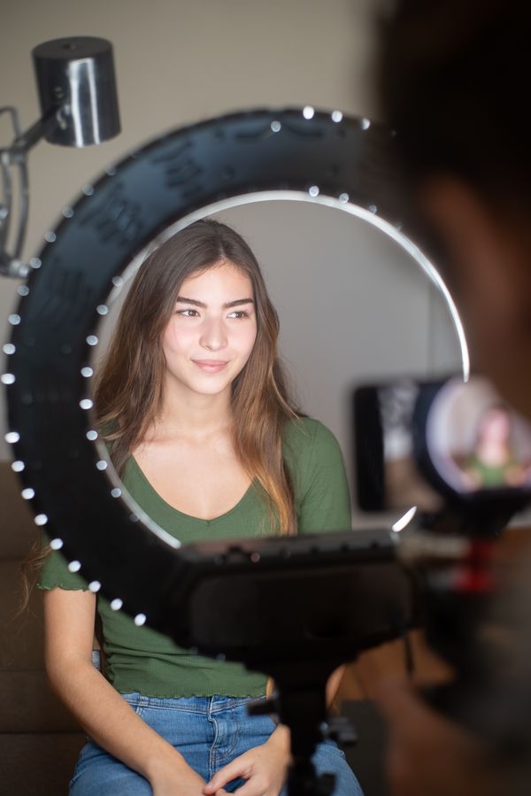 Lifestyle creator setting up a ring light to film